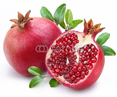 Juicy pomegranate and its half with leaves.
