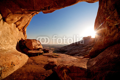 Cave and sunset in the desert mountains