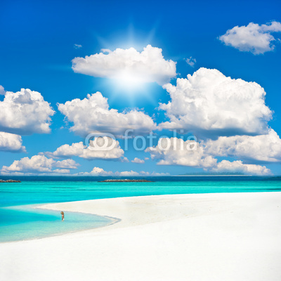 tropical sand beach over cloudy sky.