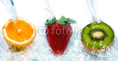 fresh fruit jumping into water with a splash