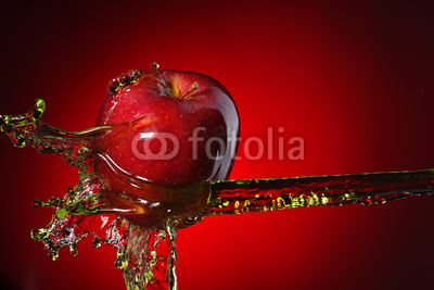 red apple in juice stream