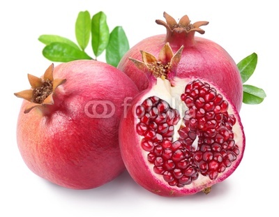 Juicy opened pomegranate with leaves.