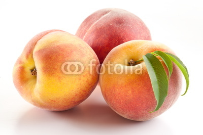 Three ripe peach with leaves