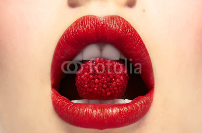 Lips bitting a berry