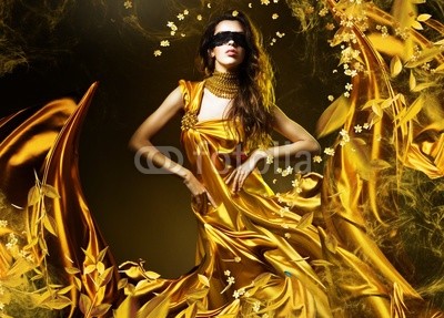 sensual adult woman in golden fabric and mask with leaves