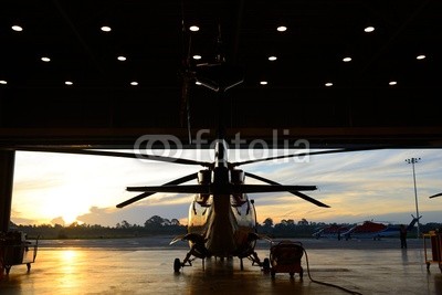 silhouette of helicopter in the hangar