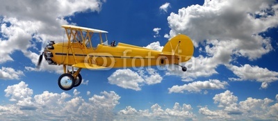 Vintage Biplane Over Clouds