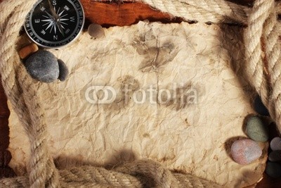 old paper, compass and rope on a wooden table