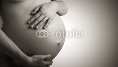 belly of pregnant woman  monochrome on dark background